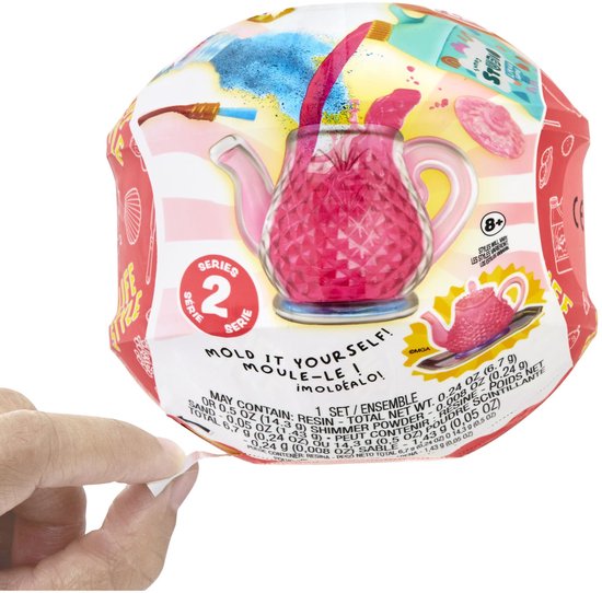Verpakking van Serie 2 'Mold It Yourself' knutselset met een roze theepot en glitters.