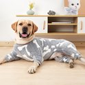 Labrador liggend in grijze pyjama met botjesprint