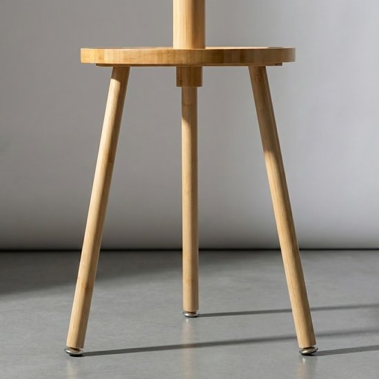 Onderkant van een bamboe kapstok met ronde tafel en drie poten.