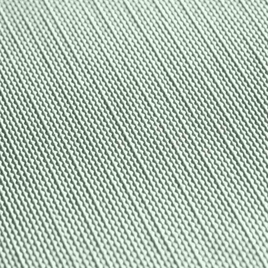 Close-up van lichtgroene stof met een geweven patroon.