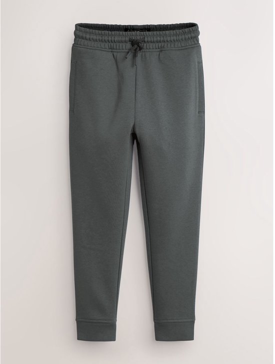 Donkergroene joggingbroek met trekkoord en elastische tailleband.