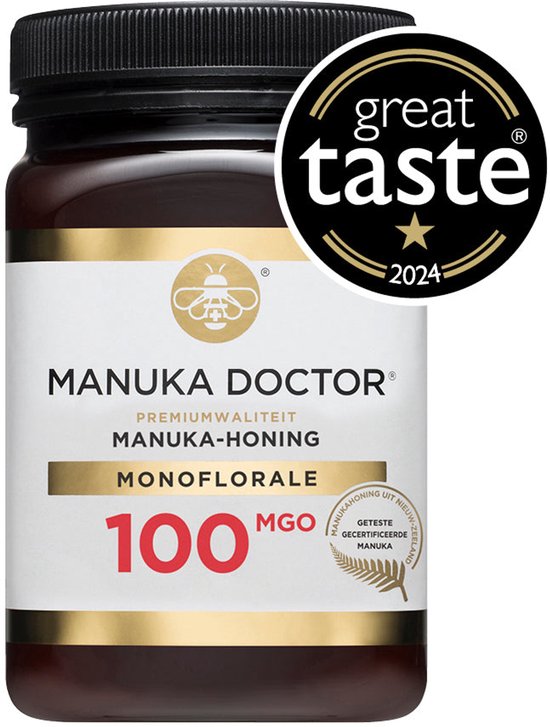 Bruine pot Manuka honing met label 'Manuka Doctor', 'Premium Kwaliteit', '100 MGO'. Bevat 'Great Taste 2024' logo.