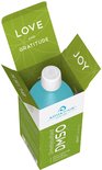 Turquoise fles in een open groene doos met de tekst 'LOVE', 'JOY' en 'GRATITUDE'.