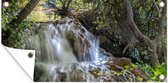 Schuttingposter Een waterval tussen de boomstammen in het Nationaal park Krka in Kroatië - 200x100 cm - Tuindoek