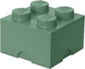 Groene LEGO opbergdoos met vier noppen op een witte achtergrond.