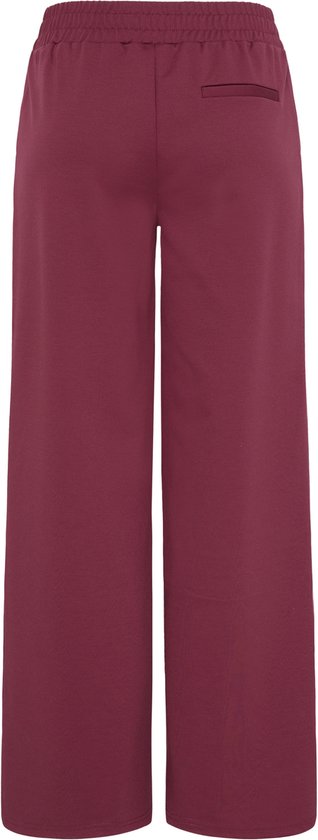 Achterkant bordeauxrode culotte met wijde pijpen.
