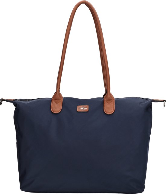 Donkerblauwe nylon tas met bruine leren handvatten, recht van voren.