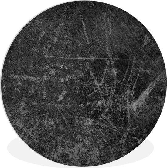 Décoration murale ronde noire aspect cuir à la texture usée.