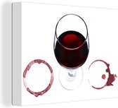 Canvas Schilderij Rode wijn en ringen op een witte achtergrond - 40x30 cm - Wanddecoratie