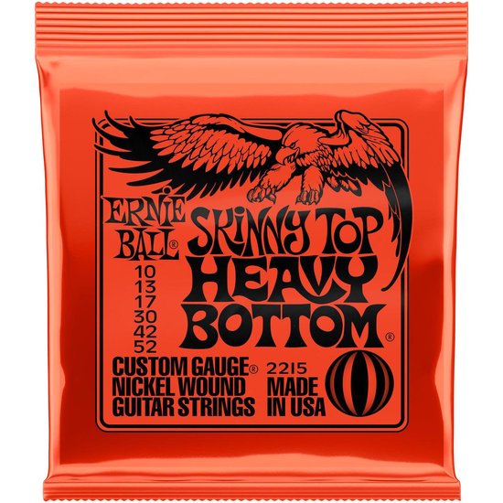 Oranje verpakking met zwarte tekst en een adelaar die een instrument vasthoudt. "Skinny Top Heavy Bottom".