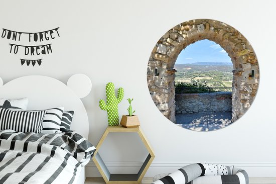 Vue depuis une arche de pierre sur une ville de France Cercle mural aluminium ⌀ 140 cm