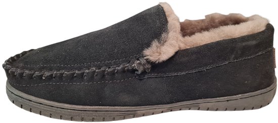 Zwarte suède sloffen met beige vachtvoering en stiksels.