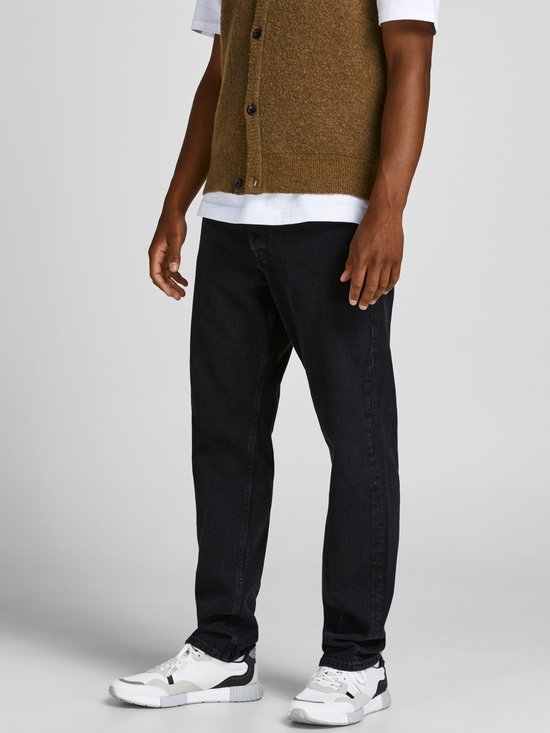 Sluiting van zwarte jeans met knopen en klinknagels.