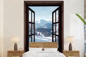 Behang - Fotobehang Winter - Landschap - Natuur - Berg - Bomen - Doorkijk - Uitzicht - Breedte 225 cm x hoogte 350 cm