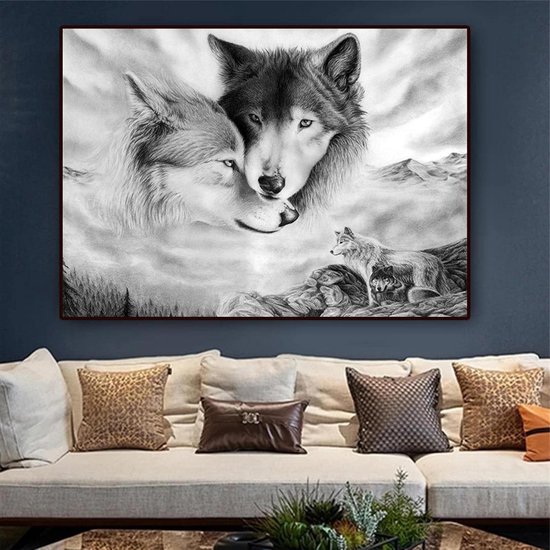 Zwart-wit canvas met wolven boven een beige bank met luipaardprint kussens in een blauwe kamer.