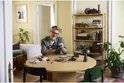 Man bouwt aan de LEGO Icons Ford Model T aan een ronde tafel.
