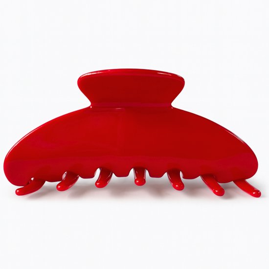 Une grosse pince à cheveux rouge brillante, fabriquée en acétate.
