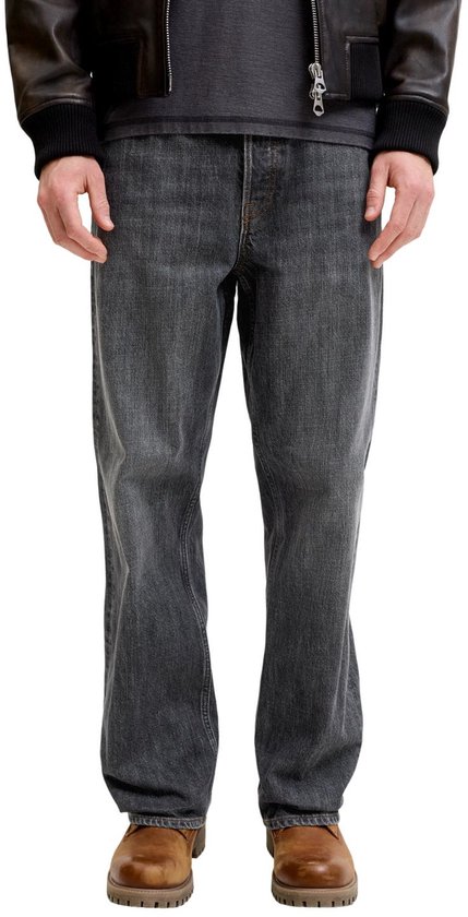 Detail van de pasvorm van een grijze jeans op een model.