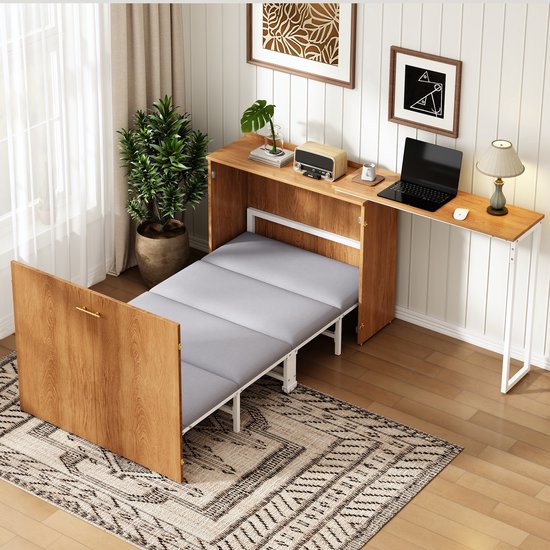 Bruin houten bedombouw met uitklapbaar bed en bureau, ingericht met laptop en plant.
