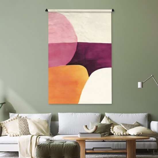 Tapisserie abstraite avec des formes roses, violettes, oranges et crème au-dessus d'un canapé blanc dans une pièce verte.