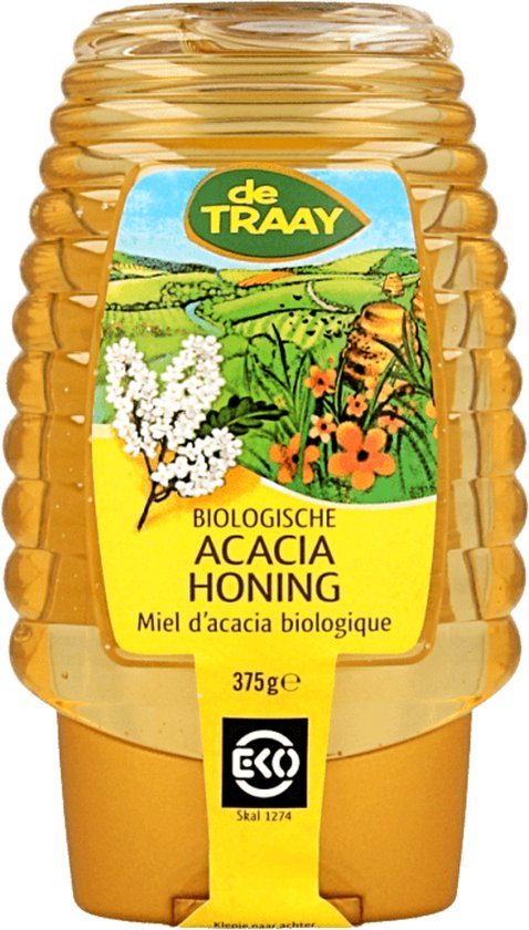 Een gele fles honing met een geel label met een honingraatontwerp. Bovenop staat de tekst 'de Traay'. Daaronder staat 'Biologische Acacia Honing' met een afbeelding van een veld.