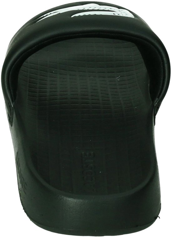 Achterkant van een zwarte slider slipper met witte krokodillenprint en 'LACOSTE' op de zool.