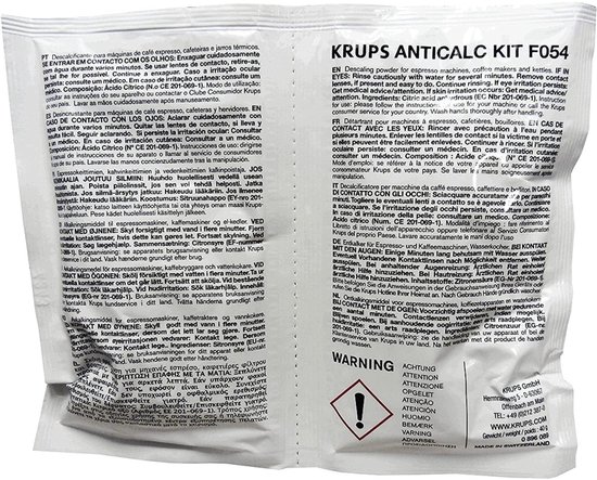 Zakje Krups Anticalc Kit F054 ontkalkingspoeder met veiligheidsinstructies in meerdere talen.