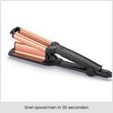 Zwarte BaByliss krultang met koperkleurige cilinders, klaar voor gebruik in 30 seconden.