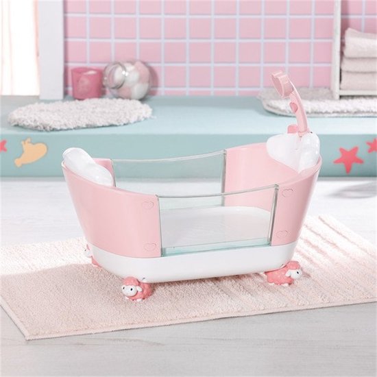 Roze babybadje met witte schaapjesvoetjes, een douchekop en een transparante rand met zeedieren afbeeldingen.