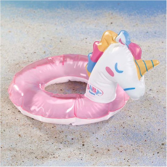 Roze glitter zwemband in eenhoornvorm op het strand.