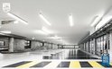 Verlichte parkeergarage met Philips lampen, betonnen pilaren en gele markeringen.