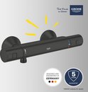 Zwarte thermostaatkraan met "GROHE" logo en "DESIGNED AND ENGINEERED IN GERMANY" tekst.