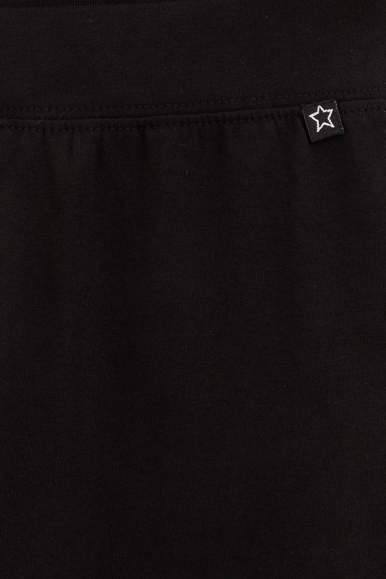 Zwarte legging met een klein wit sterlogo op de achterkant.