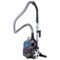 Aspirateur violet Philips avec tuyau et manche, debout sur fond blanc.