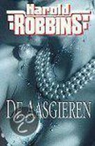 Boekomslag 'De aasgieren' van Harold Robbins met een gestileerde afbeelding van een paar