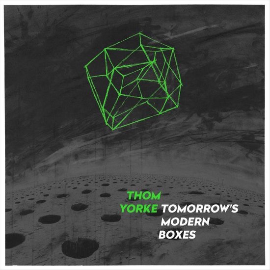 Albumhoes met de tekst "THOM YORKE TOMORROW'S MODERN BOXES" tegen een donkere, abstracte achtergrond met een neon-groen geometrisch figuur.