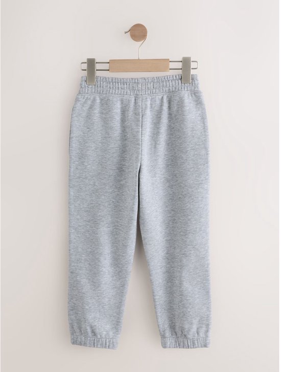 Lichtgrijze joggingbroek met elastische tailleband en zoom.