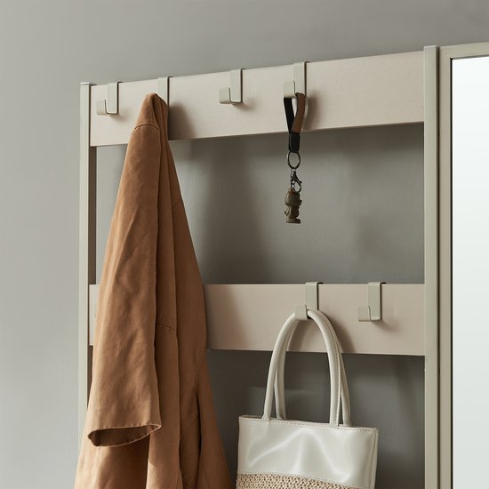 Crèmekleurige kledinghangers met jas en tas.