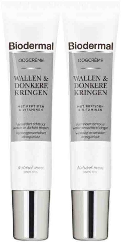 Twee tubes met Biodermal oogcrème voor wallen en donkere kringen, met peptiden & vitaminen. Tekst: "Naturel mooi Sinds 1975".