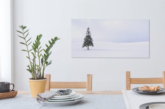 Tableau sur toile Un vide enneigé avec un sapin - 80x40 cm - Décoration murale