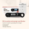 Doos met een zwarte digitale thermometer en een handleiding. De thermometer toont 156.3 graden op het display.