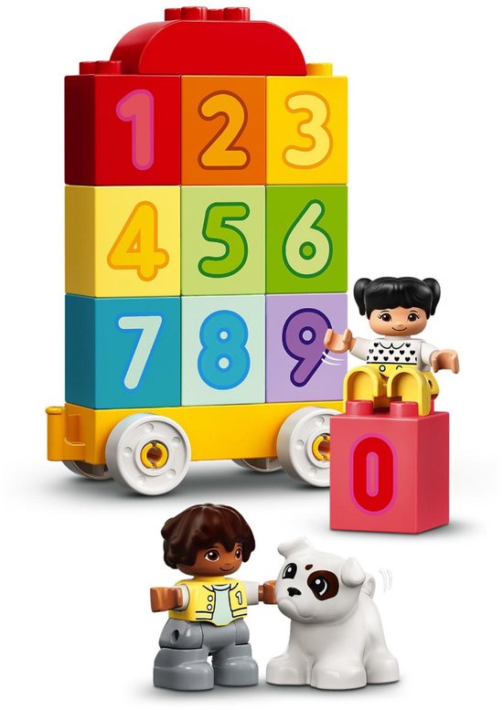 Toren van gestapelde gekleurde blokken met cijfers 0 t/m 9 op een gele wagon. Twee kinderen en een hondje.