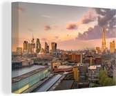 Canvas Schilderij De skyline van Londen met de Millennium Bridge op de voorgrond - 90x60 cm - Wanddecoratie