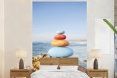 Behang - Fotobehang Stapel gekleurde stenen voor de kalme oceaan - Breedte 155 cm x hoogte 240 cm