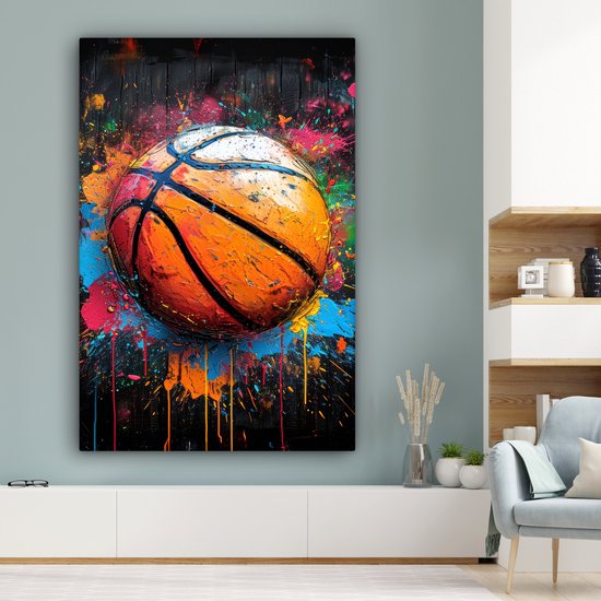 Peinture d'un ballon de basket éclaboussé de touches de peinture vive.