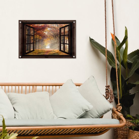 Une affiche de jardin avec une forêt d'automne en vue décore un mur blanc au-dessus d'une chaise hamac.
