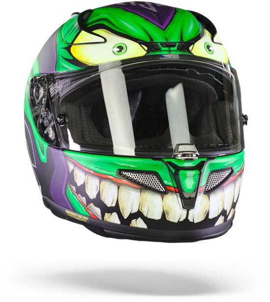 Zijaanzicht van een paarse helm met een griezelige groene Goblin-print. De helm heeft grote tanden en groene ogen.