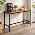 Hoge bartafel met roestbruin houten blad en zwart metalen frame, in een keukenopstelling met koffiezetapparaat en fruit.