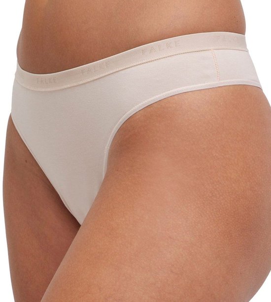 Zij-aanzicht van een beige slip met een Falke-band, close-up.