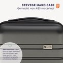 Close-up van de textuur van de stevige hardcase donkergrijze koffer, gemaakt van ABS-materiaal.